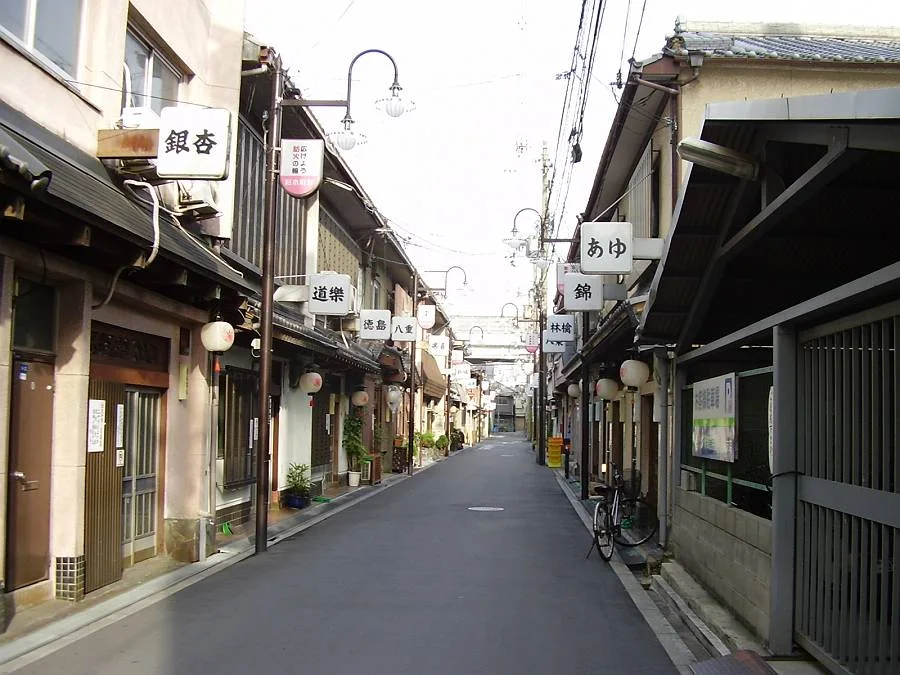 Traditional two-story buildings lining a narrow street in Tobita Shinchi, Osaka